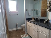 This is the bathroom that serves guests and the third bedroom. - Single Family Home for sale at 1900 Illinois Ave, Englewood, FL 34224 - MLS Number is D6121965