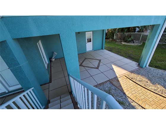 The stairs land on the ground level. - Single Family Home for sale at 1900 Illinois Ave, Englewood, FL 34224 - MLS Number is D6121965