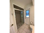 Master bathroom. Step in shower. The door you see with the window will lead into the lanai/pool area. - Single Family Home for sale at 18506 Hottelet Cir, Port Charlotte, FL 33948 - MLS Number is C7452138