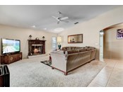 Family room with wood burning fireplace - Single Family Home for sale at 1518 Bel Air Star Pkwy, Sarasota, FL 34240 - MLS Number is A4506654