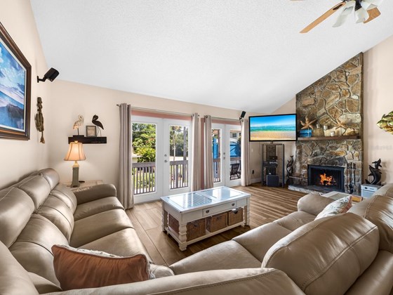 Generous living space with soaring fireplace and open air balcony. - Condo for sale at 6810 Midnight Pass Rd, Sarasota, FL 34242 - MLS Number is A4507853