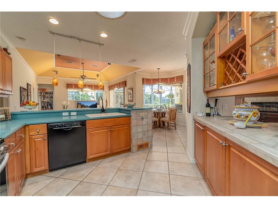 Kitchen shares Glass Double Doored Illuminated breakfront with Dining Room - Single Family Home for sale at 6521 Sundew Ct, Lakewood Ranch, FL 34202 - MLS Number is A4514104