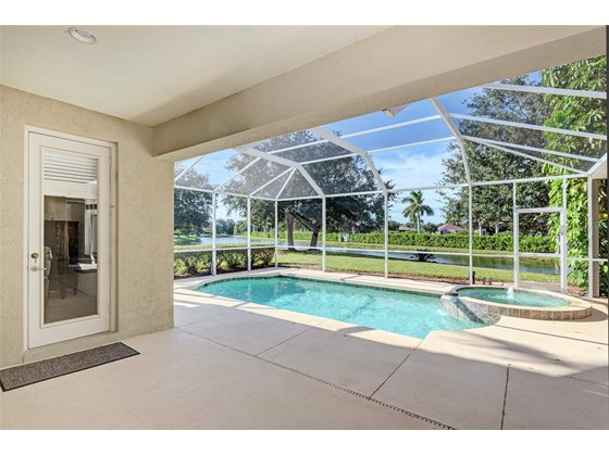 Covered Lanai; Heated pool with spa facing the lake - Single Family Home for sale at 314 Lake Tahoe Ct, Englewood, FL 34223 - MLS Number is N6117592